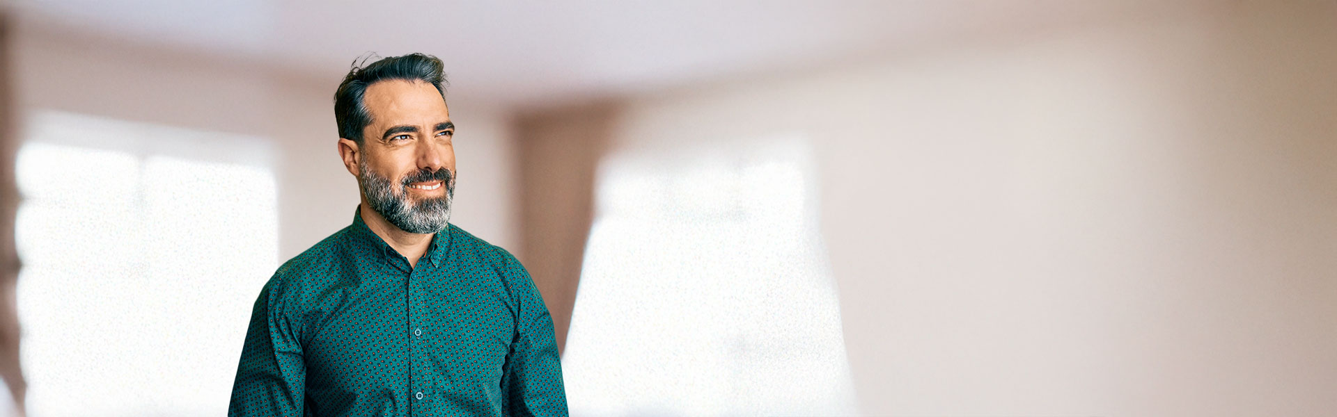 ein Mann mit Bart, der in einem Raum steht